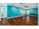 Large bonus room with dark wood floors, natural light, and plenty of space for recreation at 5843 Justicia Loop, Land O Lakes, FL 34639