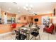 Stylish dining area with modern lighting and seating adjacent to the kitchen and living spaces at 5843 Justicia Loop, Land O Lakes, FL 34639