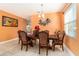 Elegant dining room with beautiful wood table, decorated chairs, tile floor, and large window at 5843 Justicia Loop, Land O Lakes, FL 34639