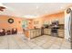 Spacious kitchen featuring stainless steel appliances, bright neutral cabinets, tile floors, and large window at 5843 Justicia Loop, Land O Lakes, FL 34639