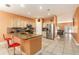 Spacious kitchen featuring a central island with seating, stainless steel appliances, and bright neutral cabinets at 5843 Justicia Loop, Land O Lakes, FL 34639