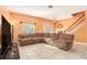 Spacious living room with tile flooring, lots of natural light and a cozy sectional sofa at 5843 Justicia Loop, Land O Lakes, FL 34639