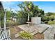 Landscaped backyard featuring a stone patio, storage shed, and a variety of foliage at 5850 21St N St # 18, St Petersburg, FL 33714