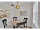 Bright dining area featuring modern chandelier, dining table, and decorative mirror at 5850 21St N St # 18, St Petersburg, FL 33714