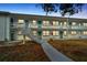 Exterior view of a multi-unit building with multiple entrances, staircases, and landscaping at 5850 21St N St # 18, St Petersburg, FL 33714