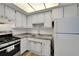 A bright kitchen with white cabinets, stainless steel appliances, and modern countertops at 5850 21St N St # 18, St Petersburg, FL 33714