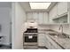 Well-lit kitchen featuring stainless steel appliances, granite counters, and ample storage at 5850 21St N St # 18, St Petersburg, FL 33714