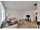 Spacious living room features sleek sofa, stylish floors, and a modern entertainment center at 5850 21St N St # 18, St Petersburg, FL 33714