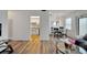 Living room view showcasing stylish hardwood floors, living area, and adjacent dining area at 5850 21St N St # 18, St Petersburg, FL 33714