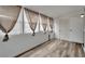 Bright room featuring new wood floors and four large windows with shades and a door at 5850 21St N St # 18, St Petersburg, FL 33714