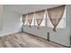 Bright room featuring new wood floors and four large windows with shades at 5850 21St N St # 18, St Petersburg, FL 33714