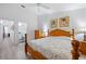 Bedroom with wood furniture, floral comforter, ceiling fan and ensuite bathroom at 5922 Bayside Key Dr, Tampa, FL 33615