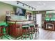 Full bar area with a bar top that has accent lighting and three barstools at 6433 Flamingo S Way, St Petersburg, FL 33707