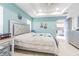 Main bedroom showcasing a neutral-toned bed with floral accents and a view into the ensuite bath at 822 E Mcewen Ave, Tampa, FL 33612