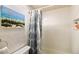 Clean bathroom featuring a shower with a decorative curtain, and a toilet at 1012 Greenleaf Way, Tarpon Springs, FL 34689