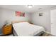 Cozy bedroom featuring a queen bed, hardwood floors, and unique decorative artwork at 1012 Greenleaf Way, Tarpon Springs, FL 34689