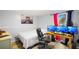 Bedroom featuring a bed, desk with dual monitors, and hardwood floors at 1012 Greenleaf Way, Tarpon Springs, FL 34689