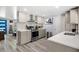 Updated kitchen with sleek stainless steel appliances, gray cabinets, and modern backsplash at 1012 Greenleaf Way, Tarpon Springs, FL 34689