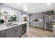 Modern kitchen with stainless steel appliances, light gray cabinets, and backyard views at 1012 Greenleaf Way, Tarpon Springs, FL 34689