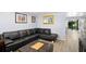 Cozy living room with a comfortable sectional sofa and a view of the dining area at 1012 Greenleaf Way, Tarpon Springs, FL 34689