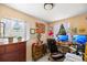 Charming home office setup with dual monitors, decorative artwork, and plenty of natural light at 1012 Greenleaf Way, Tarpon Springs, FL 34689