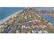 Breathtaking aerial shot of a coastal neighborhood, featuring a pristine beach, vibrant community, and stunning waterfront views at 111 22Nd St, Belleair Beach, FL 33786