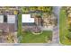Aerial view of a well-maintained home with a large, green lawn and mature trees in a serene neighborhood at 111 22Nd St, Belleair Beach, FL 33786