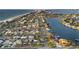 Stunning aerial view showcasing a vibrant waterfront community with boats, beaches, and city skyline at 111 22Nd St, Belleair Beach, FL 33786