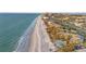 Scenic aerial view of beachfront property with sandy beach, turquoise ocean, and resort-style amenities at 111 22Nd St, Belleair Beach, FL 33786