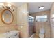 Well-lit bathroom featuring a vanity with a marble countertop and a glass-enclosed shower at 111 22Nd St, Belleair Beach, FL 33786