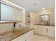 Bathroom featuring bowl sinks, granite countertop, framed mirrors, and walk-in shower at 111 22Nd St, Belleair Beach, FL 33786