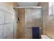 Bathroom featuring a shower with glass doors and tiled walls at 111 22Nd St, Belleair Beach, FL 33786