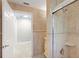 Bathroom showcasing tiled walls, neutral colors, and a shower with glass door at 111 22Nd St, Belleair Beach, FL 33786