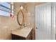 Bathroom featuring vanity with marble countertop and an oval mirror at 111 22Nd St, Belleair Beach, FL 33786