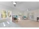 Bright bedroom with carpet, two ceiling fans, windows with shutters, and access to backyard at 111 22Nd St, Belleair Beach, FL 33786
