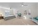 Bright bedroom featuring carpet, two ceiling fans, and shuttered windows at 111 22Nd St, Belleair Beach, FL 33786