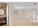 Spacious bedroom leading into a bathroom, with carpeted floors and natural light at 111 22Nd St, Belleair Beach, FL 33786