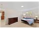Bedroom featuring carpet, dresser, window, and view into kitchen at 111 22Nd St, Belleair Beach, FL 33786