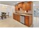 Traditional kitchen with stainless steel dishwasher and wood cabinets overlooking dining room at 111 22Nd St, Belleair Beach, FL 33786