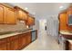 Traditional kitchen with stainless steel appliances, granite countertops, and tile flooring at 111 22Nd St, Belleair Beach, FL 33786