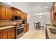 Well-equipped kitchen with stainless steel appliances and granite countertops opening to the dining area at 111 22Nd St, Belleair Beach, FL 33786
