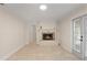 Living room with tiled floor, a fireplace, and a set of glass doors at 111 22Nd St, Belleair Beach, FL 33786
