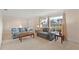 Spacious living room with neutral tones, soft carpeting, and cozy couches next to bright windows at 111 22Nd St, Belleair Beach, FL 33786
