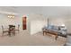 Open-concept living and dining area with plush carpeting and elegant decor leading to the kitchen at 111 22Nd St, Belleair Beach, FL 33786