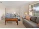Inviting living room with two sofas, area rug, and a large window providing ample natural light at 111 22Nd St, Belleair Beach, FL 33786