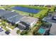 Aerial view of a home with a screened pool, pond, and manicured landscaping at 11605 Cleyera Ct, Riverview, FL 33579