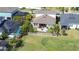 An aerial perspective shows the backyard, patio and lush green lawn, complemented by mature palm trees at 11605 Cleyera Ct, Riverview, FL 33579