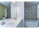 Bathroom with double sinks, bright vanity lights, and a tub-shower combination at 11605 Cleyera Ct, Riverview, FL 33579