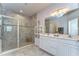 Bathroom showcases a double vanity, a glass-enclosed shower with tiled walls, and modern fixtures for a spa-like feel at 11605 Cleyera Ct, Riverview, FL 33579