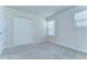 Neutral bedroom with plush carpet, a double window and double closet doors at 11605 Cleyera Ct, Riverview, FL 33579
